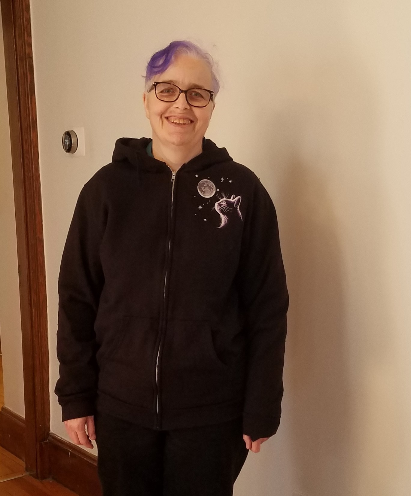 cat hoodie me wearing a black jacket with embroidered cat